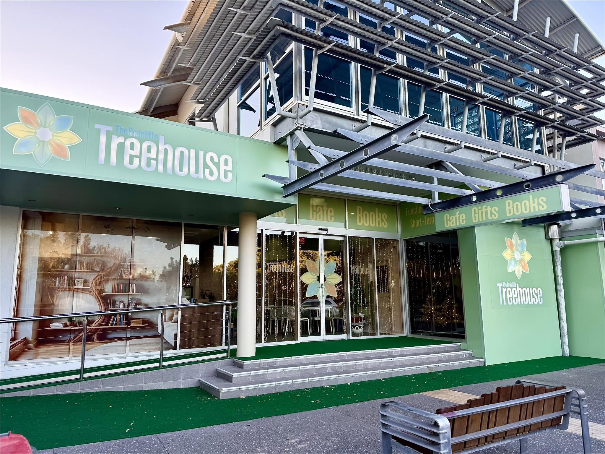 Green storefront with 'Treehouse' branding, including a cafe, books, and gift section.